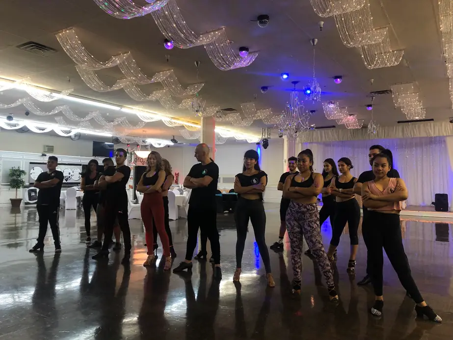 A class lined up for a lesson in a ballroom